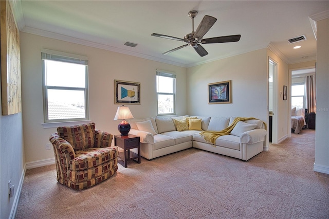 living room featuring ceiling fan, light colored carpet, and ornamental molding