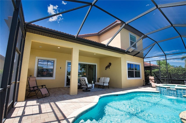 view of swimming pool with an in ground hot tub, a lanai, and a patio area