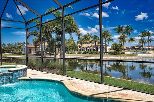 view of pool with glass enclosure, an in ground hot tub, and a water view