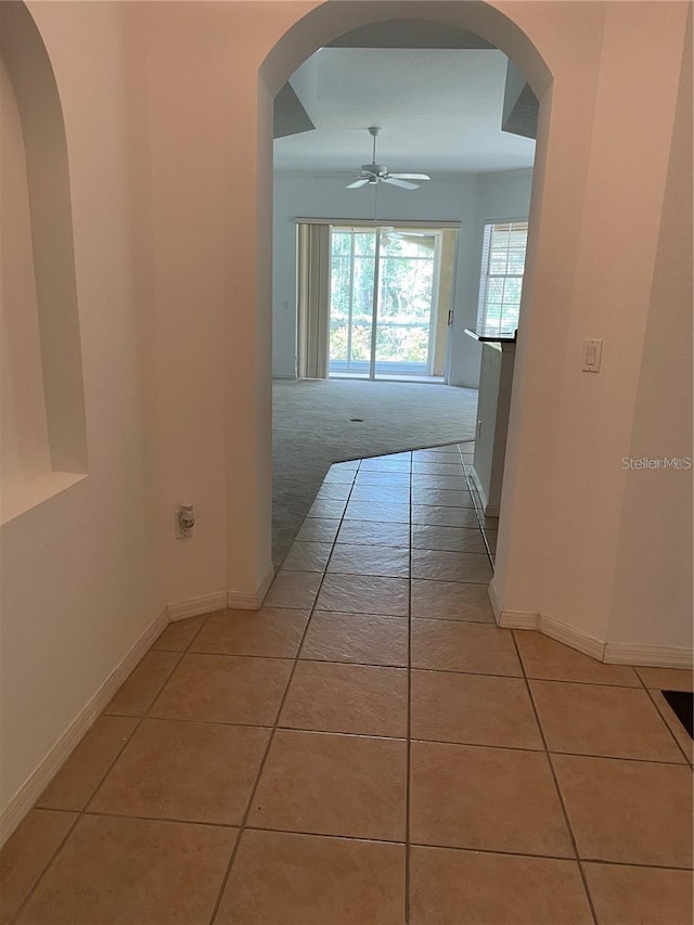 hall featuring light tile patterned floors