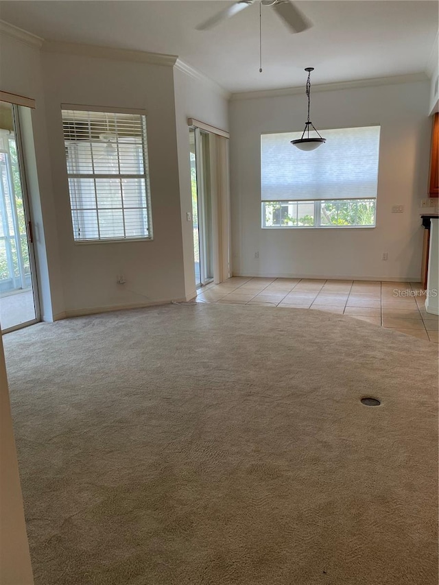 tiled empty room with ceiling fan and ornamental molding