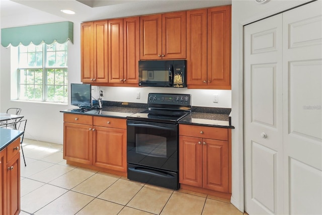 kitchen with black appliances and light tile patterned flooring