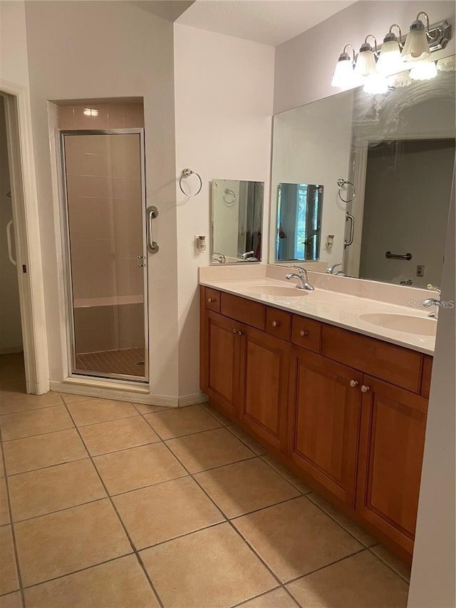 bathroom with tile patterned floors, vanity, and a shower with shower door