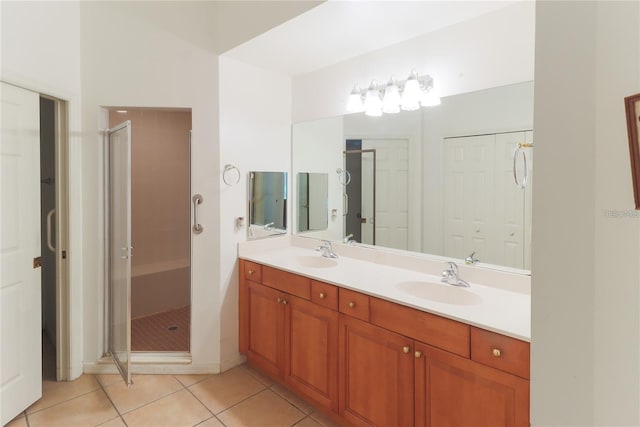 bathroom with tile patterned flooring, vanity, and walk in shower