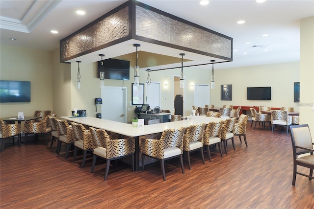 bar with crown molding, hanging light fixtures, and dark hardwood / wood-style floors