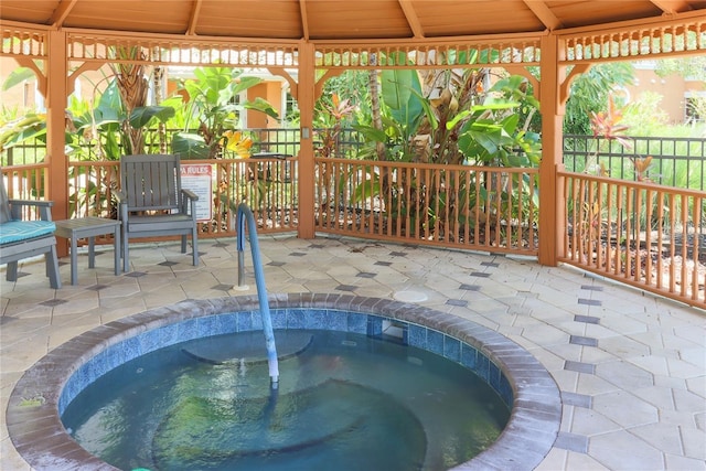 view of pool with sink, a patio, and a hot tub