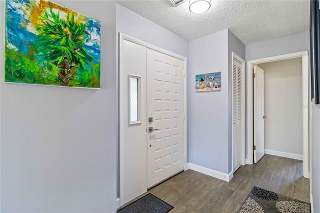 entryway featuring hardwood / wood-style floors and a textured ceiling