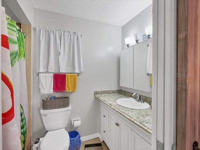 bathroom featuring toilet, vanity, a textured ceiling, and curtained shower