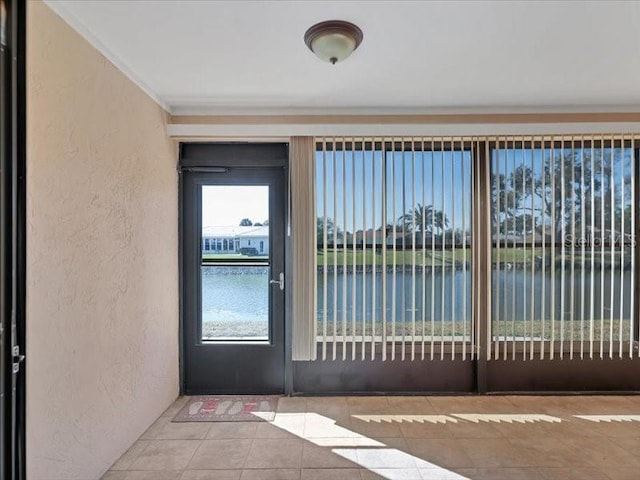 doorway to property with a water view