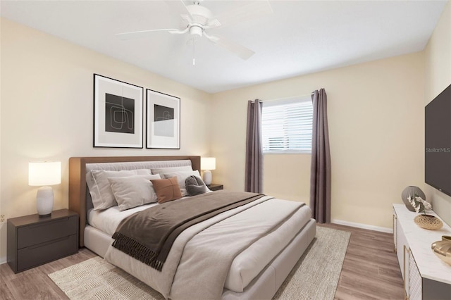 bedroom with light wood-type flooring and ceiling fan