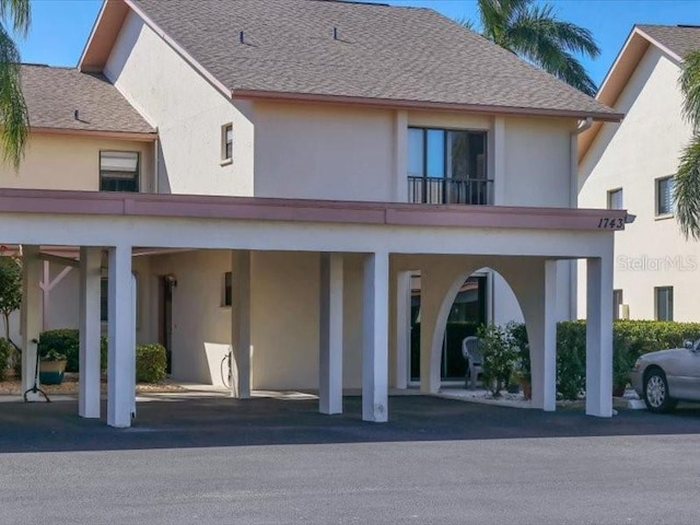 back of house with a carport