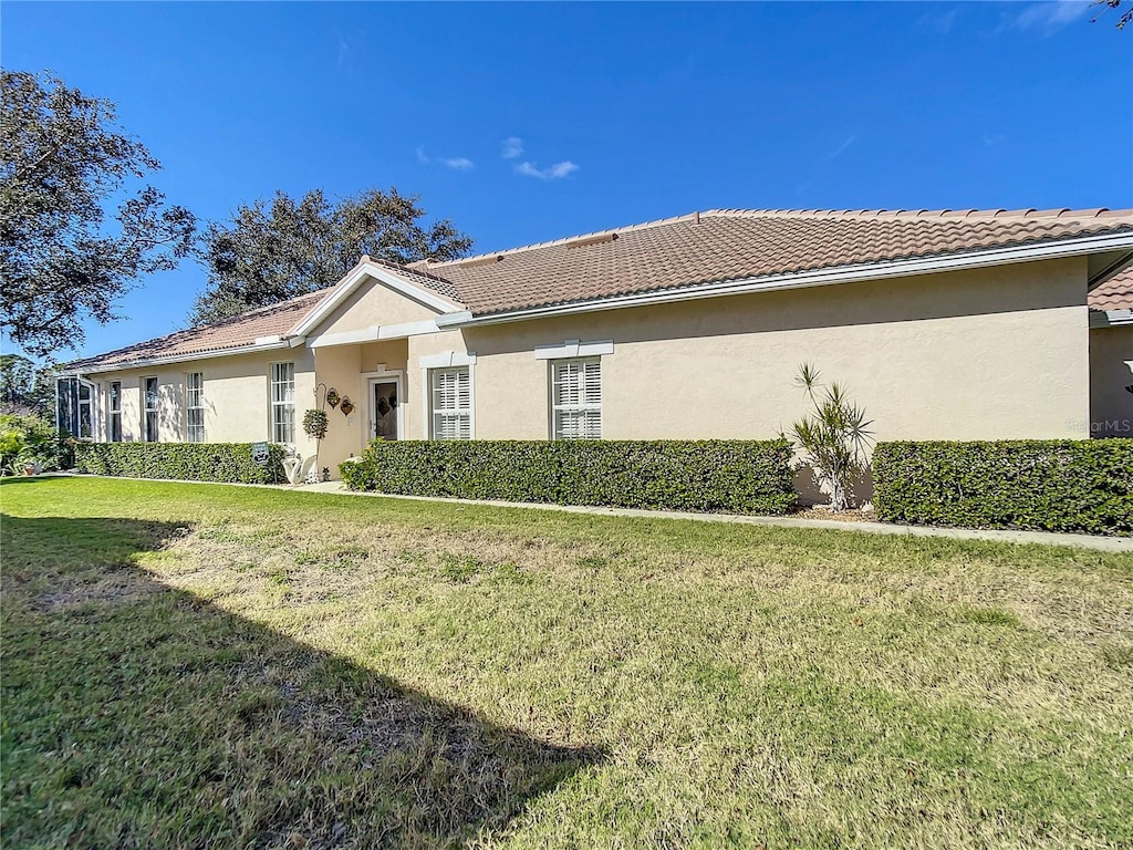 view of side of home featuring a lawn