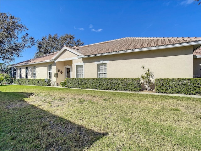 view of side of home featuring a lawn