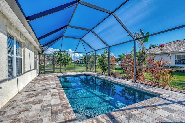 view of swimming pool with a patio and glass enclosure