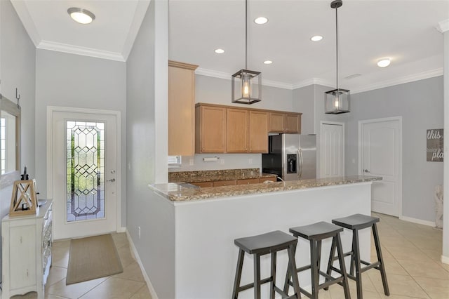 kitchen featuring stainless steel fridge with ice dispenser, kitchen peninsula, crown molding, decorative light fixtures, and light tile patterned floors