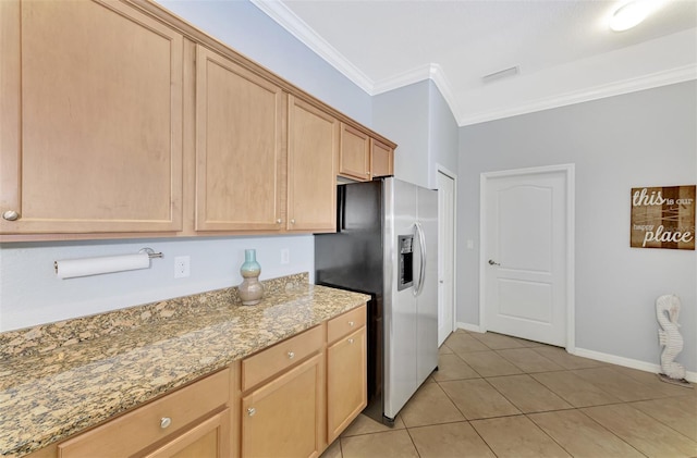 kitchen featuring light stone counters, stainless steel refrigerator with ice dispenser, light brown cabinetry, light tile patterned floors, and ornamental molding