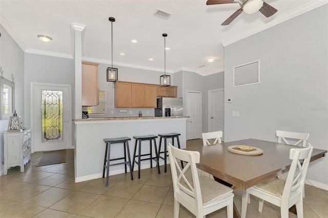 dining space with ceiling fan, light tile patterned floors, and ornamental molding