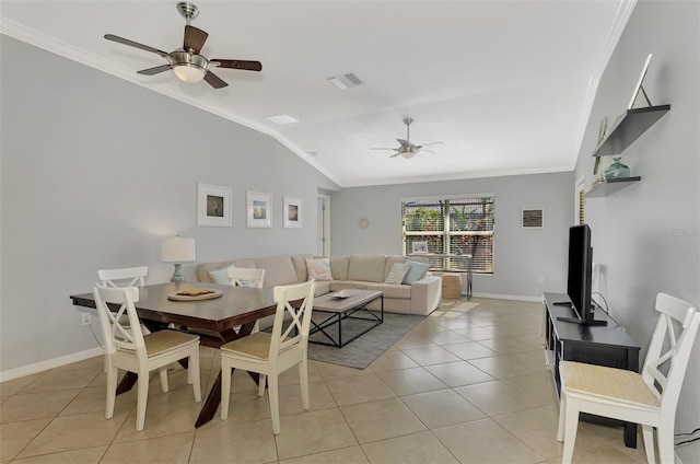 tiled dining room featuring ceiling fan, lofted ceiling, and ornamental molding