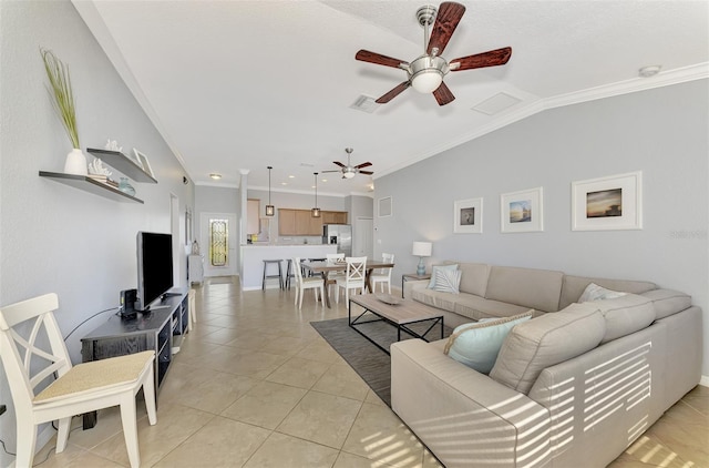 living room featuring ornamental molding, light tile patterned floors, and lofted ceiling