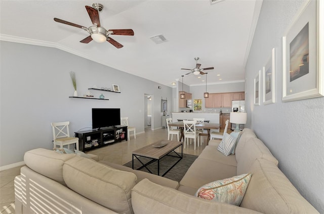 tiled living room with lofted ceiling, ceiling fan, and ornamental molding