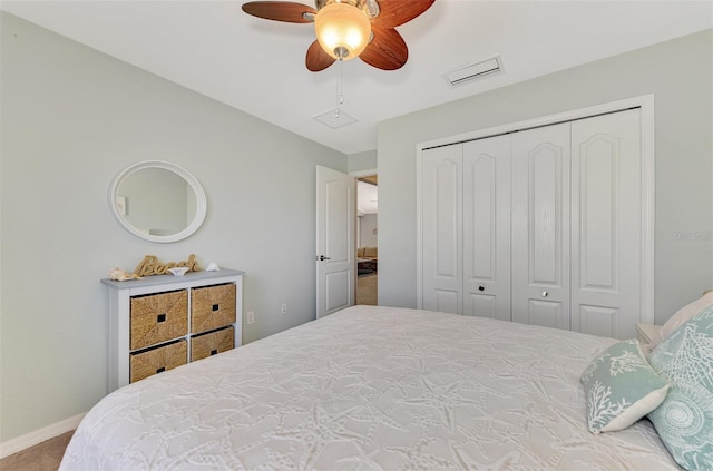 carpeted bedroom with ceiling fan and a closet