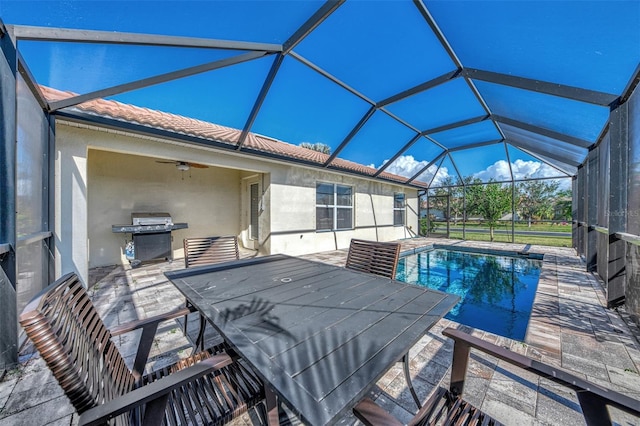 view of swimming pool featuring a lanai, ceiling fan, area for grilling, and a patio area