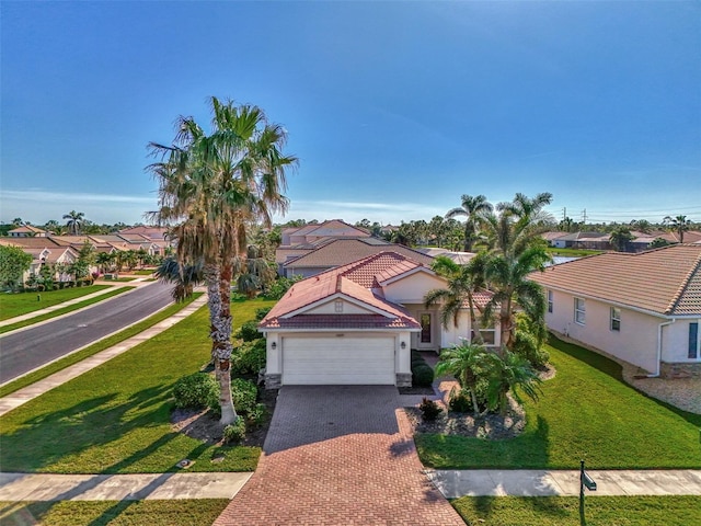 11679 Anhinga Ave, Venice, FL 34292 - mediterranean / spanish house with decorative driveway, a garage, stucco siding, a residential view, and a front lawn