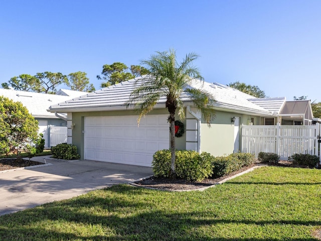 view of property exterior featuring a lawn and a garage