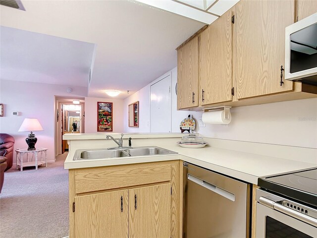 kitchen with dishwasher, sink, light colored carpet, and light brown cabinets