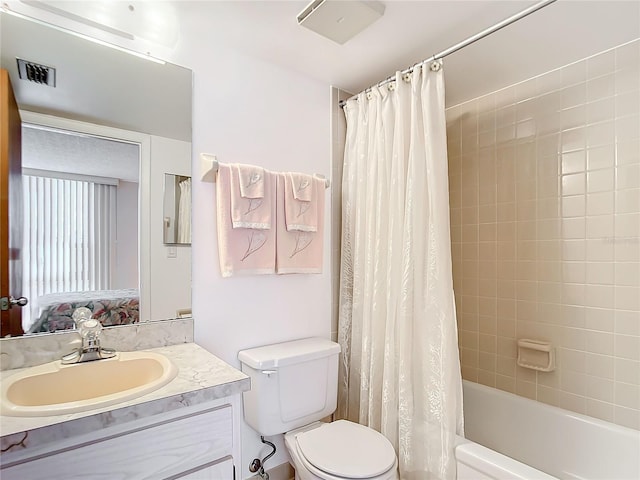 full bathroom featuring shower / bath combo with shower curtain, vanity, and toilet