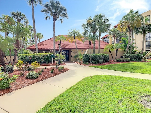 mediterranean / spanish home featuring a front lawn