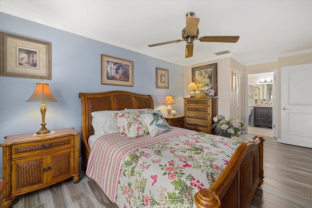 bedroom with ensuite bathroom, light hardwood / wood-style flooring, ceiling fan, and ornamental molding