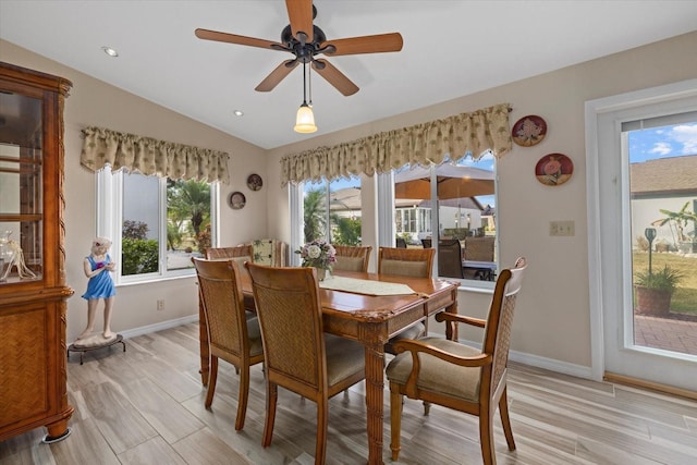 dining room featuring light hardwood / wood-style flooring, ceiling fan, and lofted ceiling