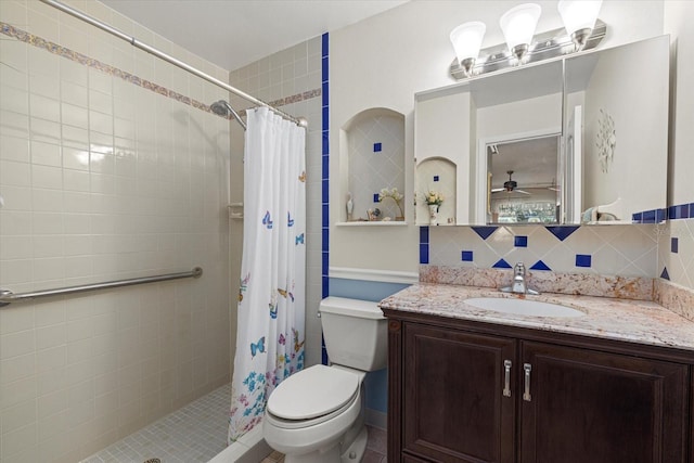 bathroom featuring vanity, tasteful backsplash, curtained shower, and ceiling fan