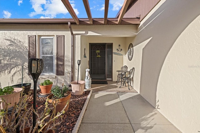 entrance to property with a patio