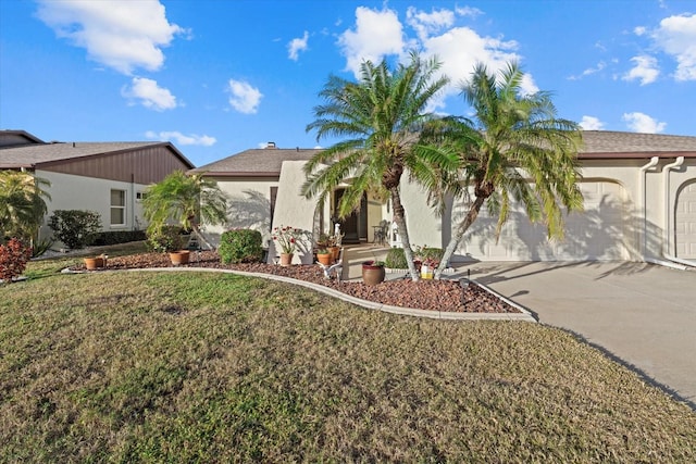 view of front of property featuring a garage and a front lawn