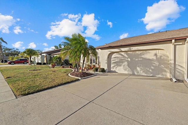 view of front of property with a garage and a front lawn