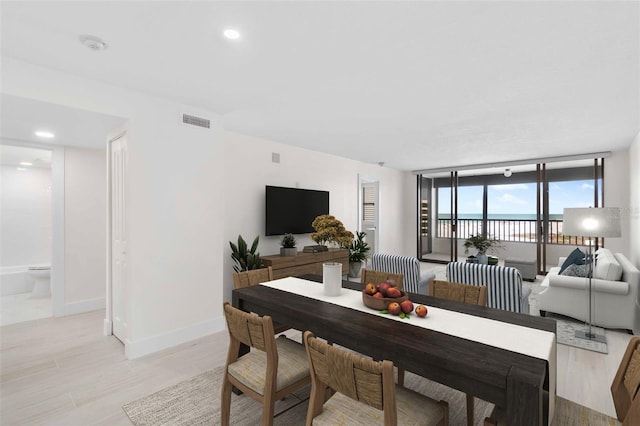 dining space with floor to ceiling windows