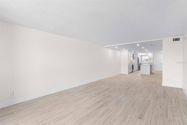 unfurnished living room with a textured ceiling