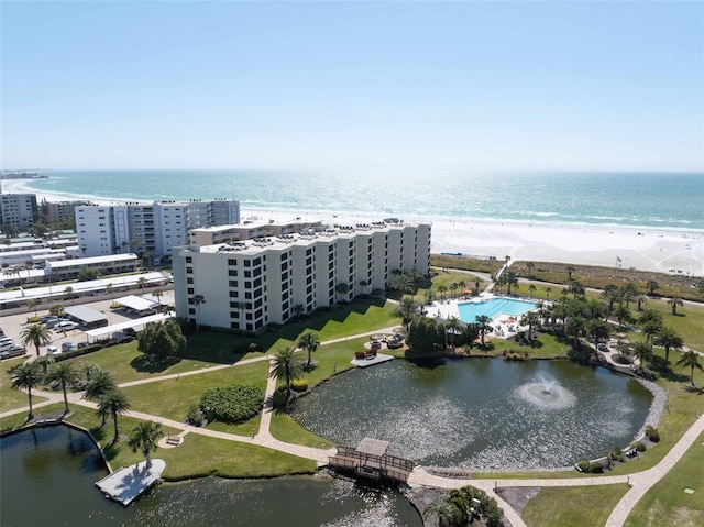 birds eye view of property featuring a water view and a beach view