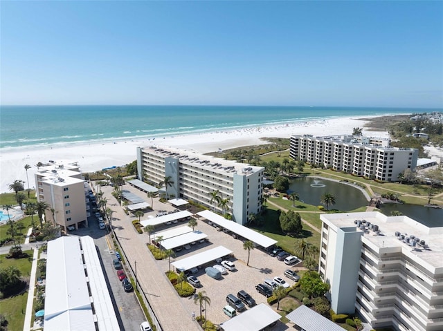 birds eye view of property featuring a water view and a view of the beach