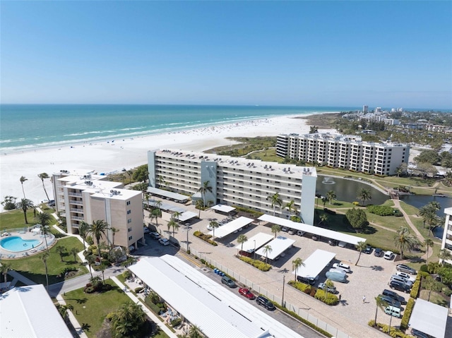 bird's eye view featuring a water view and a view of the beach