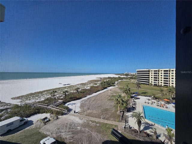 birds eye view of property with a water view and a view of the beach