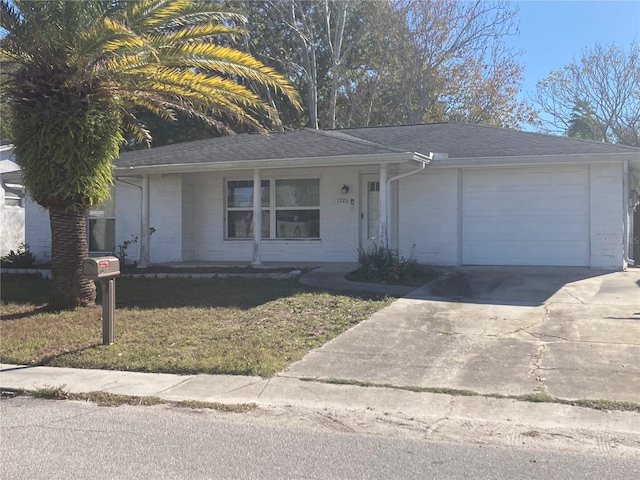 ranch-style home with a garage and a front lawn