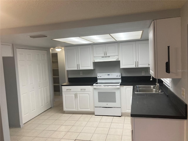 kitchen featuring light tile patterned floors, electric range, white cabinetry, and sink