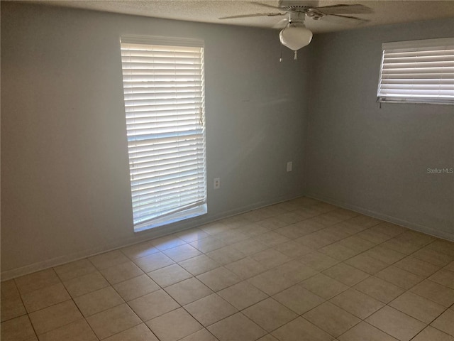 empty room featuring ceiling fan and light tile patterned flooring