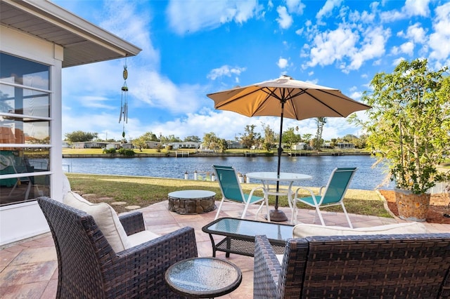 view of patio with a water view and an outdoor fire pit