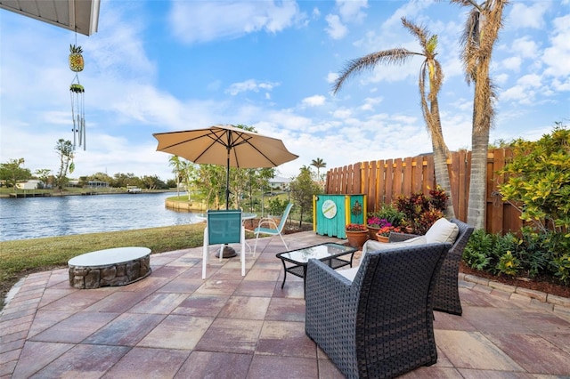 view of patio / terrace with a water view and a fire pit