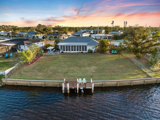 aerial view at dusk with a water view