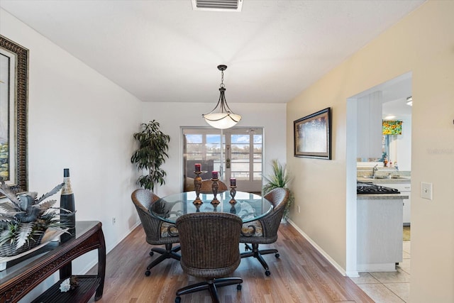 dining room with light wood-type flooring and sink